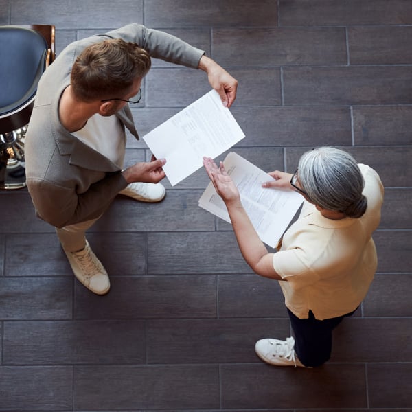 Photograph of two finance leaders discussing financial reports